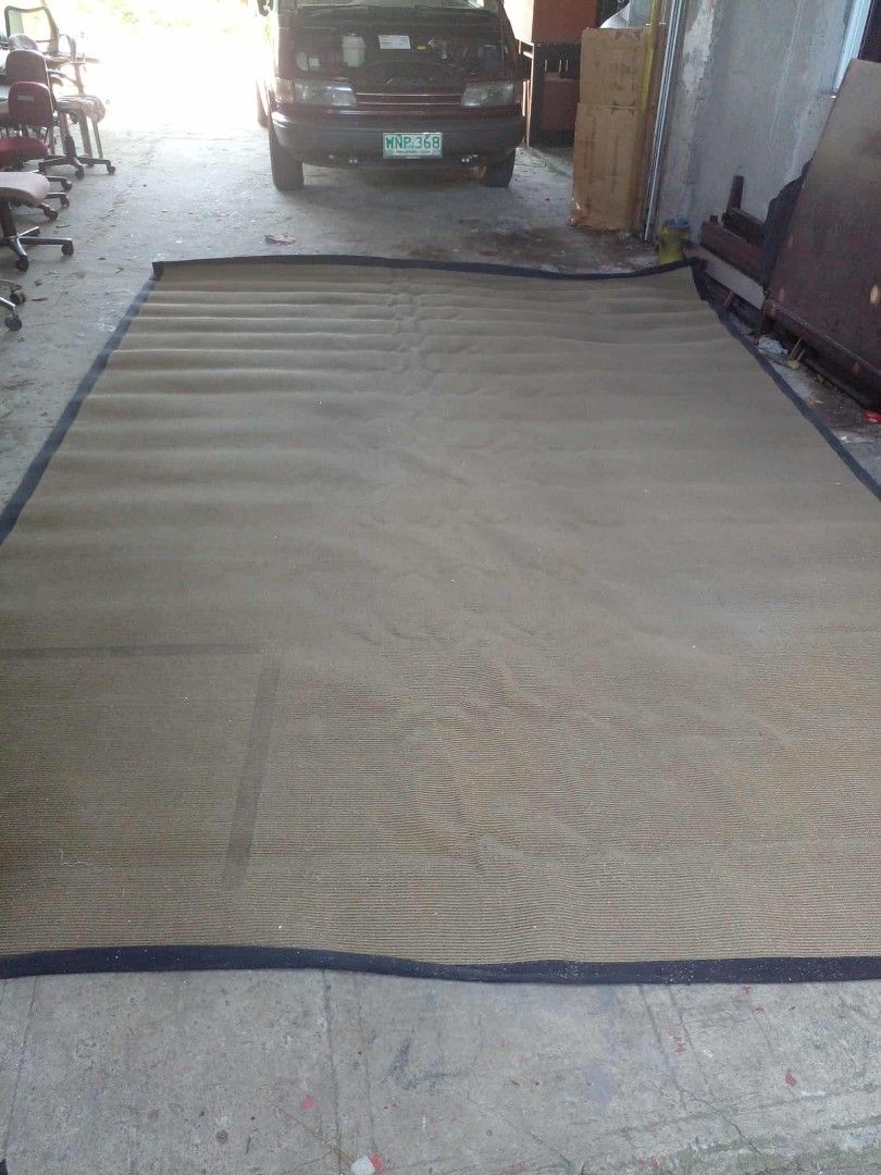 Large brown woven area rug with dark border (Category: Carpets, Mats & Flooring) located in Manila. Submitted by wisegem-231b (Listing ID 1470398936, Image 1). Description: - Type: Large floor carpet - Material: Brown woven material with dark blue border trim - Shape: Rectangular - Size: Spacious, covers a big floor area - Style: Neutral earthy tone suitable for living rooms, bedrooms, or office spaces.