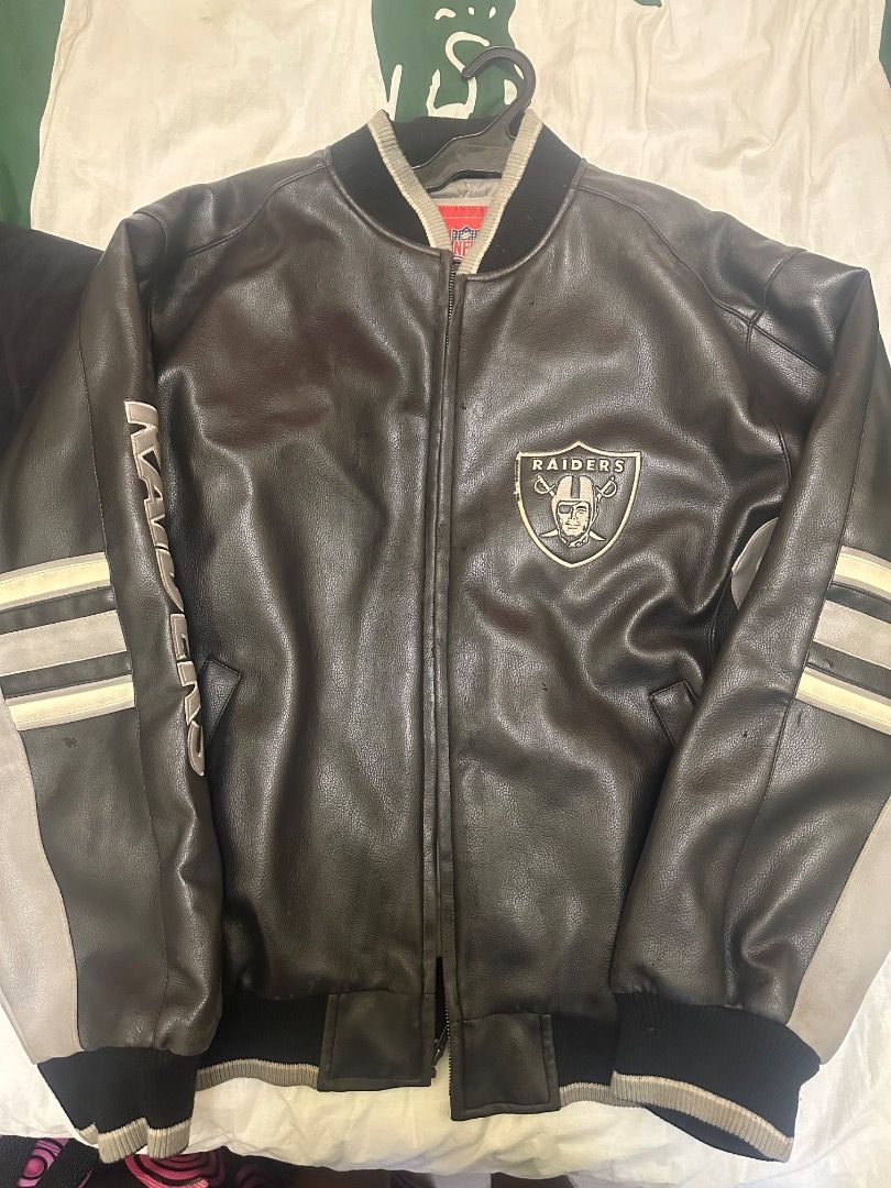 Las Vegas Raiders NFL Leather Bomber Jacket (Category: Coats, Jackets and Outerwear) located in Caloocan City. Submitted by tradermac (Listing ID 1470537537, Image 3). Description: - Authentic Las Vegas Raiders heavyweight leather jacket - Color: Classic black with grey and white striped detailing on sleeves - Features: Raiders logo patch on left chest and Raiders lettering down the right sleeve - Comfort: Ribbed collar, cuffs, and hem with front
