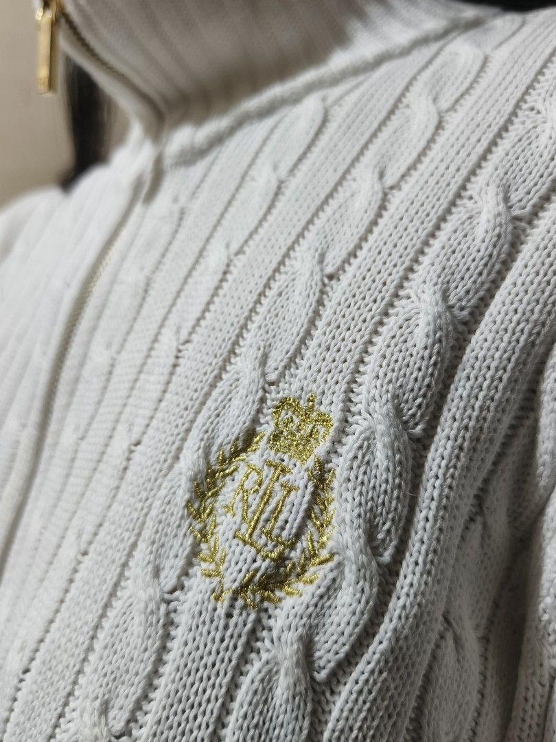 RL Ralph Lauren White Knitted Jacket (Category: Coats, Jackets and Outerwear) located in Batangas. Submitted by arbi_sel (Listing ID 1470492042, Image 3). Description: - Brand: Lauren Ralph Lauren - Style: Cable knit full-zip jacket - Color: White with gold-tone hardware - Details: Embroidered LRL crest on the chest - Size: Small (16" width x 22" length) - Model: 5'0 - Needs a wash before wearing.