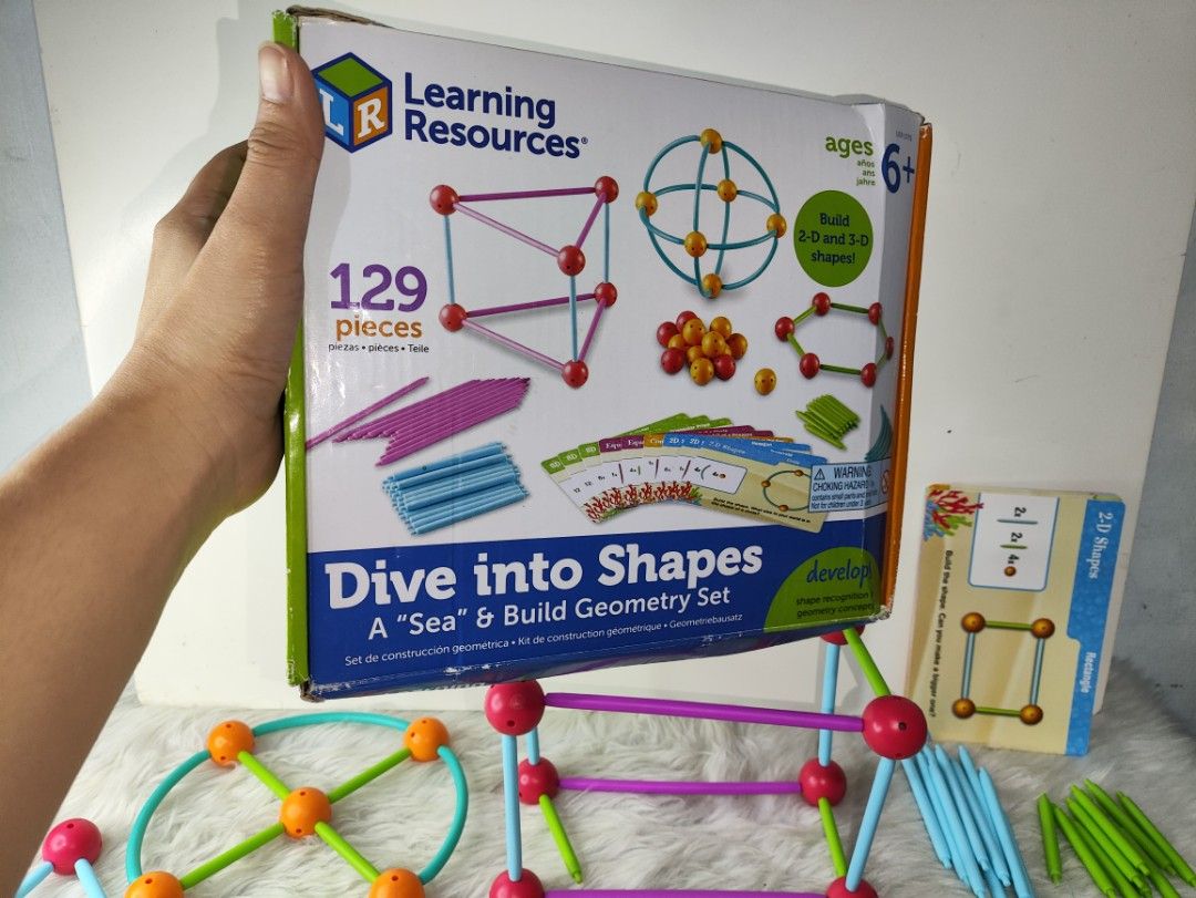 Learning Resources Dive into Shapes Geometry Set 129 Pieces (Category: Educational & Learning Toys) located in Cavite. Submitted by tinetaclesss (Listing ID 1470408495, Image 2). Description: Learning Resources Dive into Shapes geometry set with 129 pieces. Build 2D and 3D shapes. Includes rods, connector balls, curved pieces, and activity cards. Original box included. Great educational toy for kids learning math and shapes. Everything is laid ou