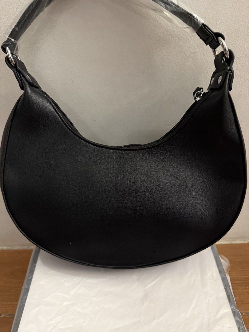 Legentiz Black Shoulder Bag Crescent Hobo (Category: Shoulder Bags) located in Bulacan. Submitted by emjay_17 (Listing ID 1470429631, Image 2). Description: - Brand: Legentiz - Style: Black crescent shoulder bag (never used, clean shape) - Material: Smooth faux leather with silver-tone hardware - Closure: Secure zipper closure - Branding: Brand logo printed on the front - Interior: Brown lining with an extra zipper pocket - Condition: Brand new, 