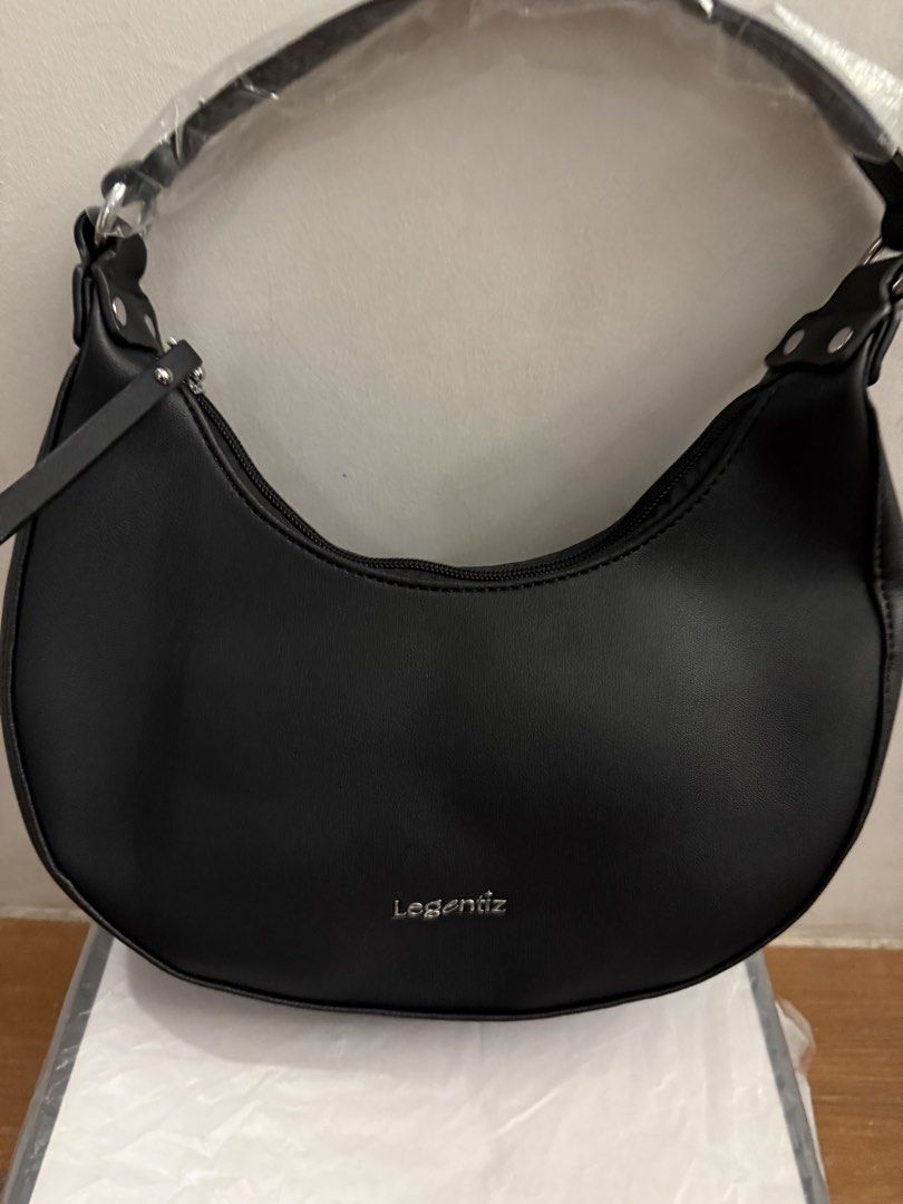 Legentiz Black Shoulder Bag Crescent Hobo (Category: Shoulder Bags) located in Bulacan. Submitted by emjay_17 (Listing ID 1470429631, Image 1). Description: - Brand: Legentiz - Style: Black crescent shoulder bag (never used, clean shape) - Material: Smooth faux leather with silver-tone hardware - Closure: Secure zipper closure - Branding: Brand logo printed on the front - Interior: Brown lining with an extra zipper pocket - Condition: Brand new, 