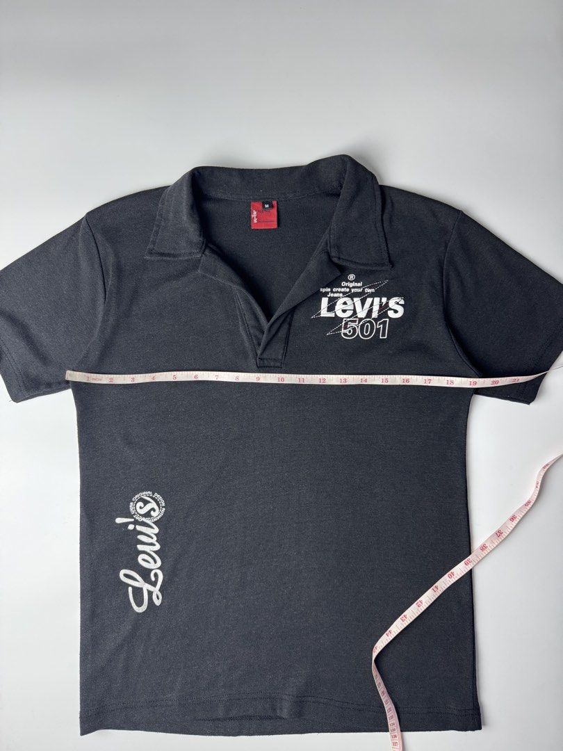 Levi's 501 Black Polo Shirt (Category: Tshirts & Polo Shirts ) located in Cavite. Submitted by dracokidstuff (Listing ID 1470375352, Image 3). Description: - Brand: Levi's Red Tab 501 - Color: Black - Size: Men's Medium - Design: Graphic print on chest, script logo near hem, large branding on back shoulders - Style: Short sleeves, classic collar, V-neck placket - Pit-to-Pit: ~20.5 inches - Length: ~24.5 inches.
