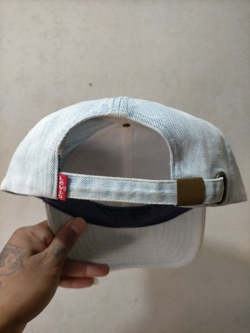Levi's Light Wash Denim Baseball Cap (Category: Caps & Hats) located in Manila. Submitted by zenphoenix_b0c89e (Listing ID 1470443771, Image 3). Description: - Brand: Levi Strauss & Co. - Material: 100% cotton light wash denim - Design: Iconic front leather two-horse patch and red Levi's tab - Closure: Adjustable strapback with durable brass clasp - Interior: Clean lining with branded top button - Origin: Made in China - Condition: Excellent pre-