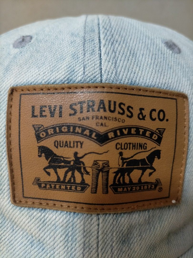 Levi's Light Wash Denim Baseball Cap (Category: Caps & Hats) located in Manila. Submitted by zenphoenix_b0c89e (Listing ID 1470443771, Image 2). Description: - Brand: Levi Strauss & Co. - Material: 100% cotton light wash denim - Design: Iconic front leather two-horse patch and red Levi's tab - Closure: Adjustable strapback with durable brass clasp - Interior: Clean lining with branded top button - Origin: Made in China - Condition: Excellent pre-