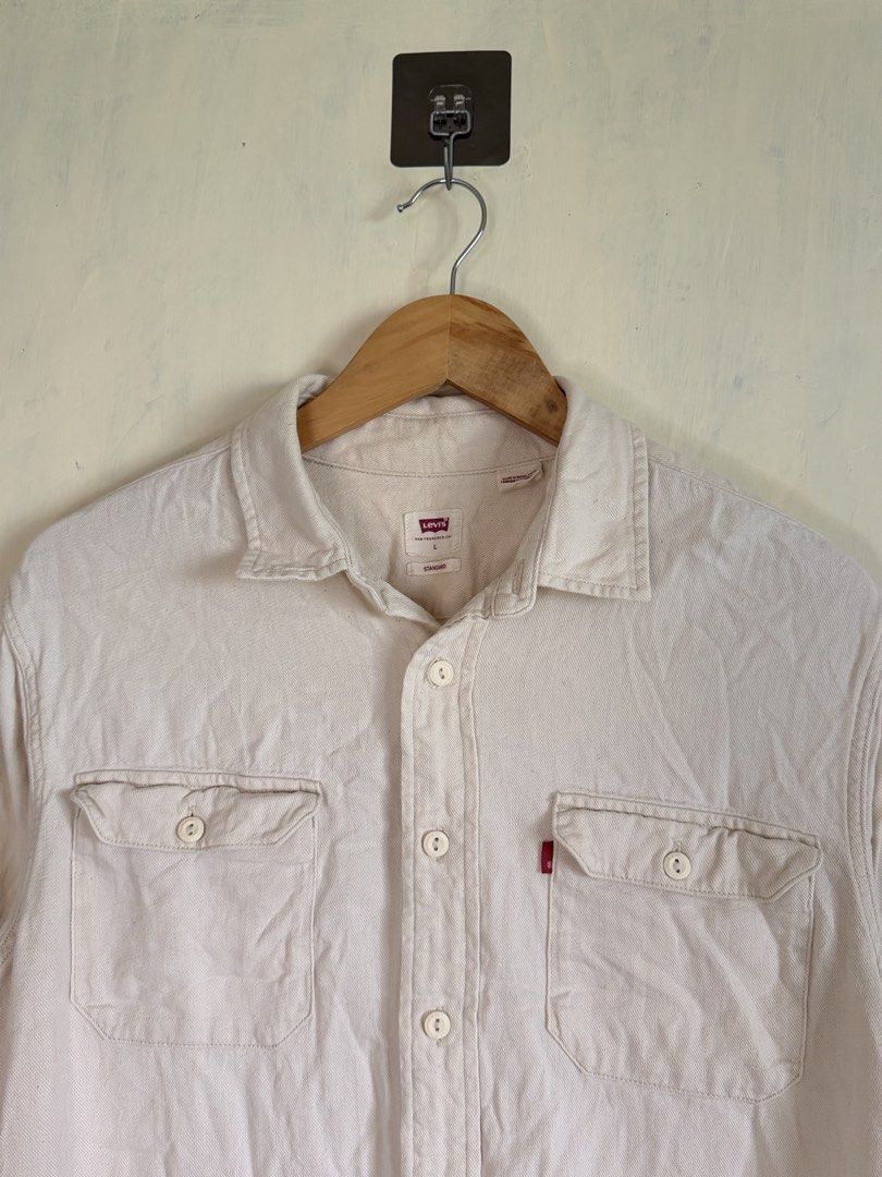 Levi's Standard Fit Off-White Button-Down Shirt Size L (Category: Formal Shirts) located in Manila. Submitted by snipe.shit (Listing ID 1470424710, Image 2). Description: - Brand: Levi's - Style: Long sleeve button-down shirt - Color: Off-white - Size: Large - Material: Solid cotton-blend twill - Details: Dual chest pockets, signature red tab logo, standard collar, button cuffs - Condition: Excellent, well-maintained - Shipping: Ships out via J&T