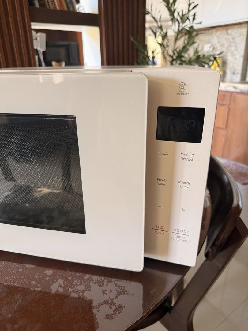 LG Inverter Microwave Oven White (Category: Ovens & Toasters) located in Muntinlupa City. Submitted by rnrsnpstr (Listing ID 1470397581, Image 2). Description: - Brand/Model: LG Countertop Microwave - Color/Design: Clean white finish with a sleek glass front and minimalist aesthetic - Controls: Easy-to-use right-side touch panel with a clear digital display - Features: Advanced Inverter technology for precise defrosting and cooking - Condition: D