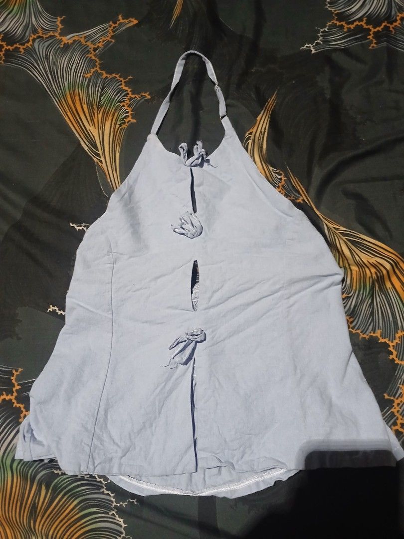 Light blue halter neck top with front tie details (Category: Sleeveless) located in Manila. Submitted by iiselou (Listing ID 1470498391, Image 1). Description: - Color: Light blue - Style: Halter neck, sleeveless with adjustable strap - Detail: Cute small front tie closure - Material: Lightweight and comfortable - Versatile: Perfect to match with jeans or skirts for casual days - Measurements available upon request (just DM me!).