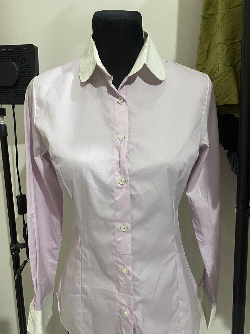 Light Purple Long Sleeve Button Down Shirt with White Collar (Category: Longsleeves) located in Manila. Submitted by mpt99876 (Listing ID 1470496213, Image 2). Description: - Color: Light purple with contrasting white pointed collar and cuffs - Fit: Tailored with bust darts and waist seams for a flattering silhouette - Details: Front button closure, lightweight fabric with a slight sheen - Condition: Excellent - Perfect for: Office wear, intervie