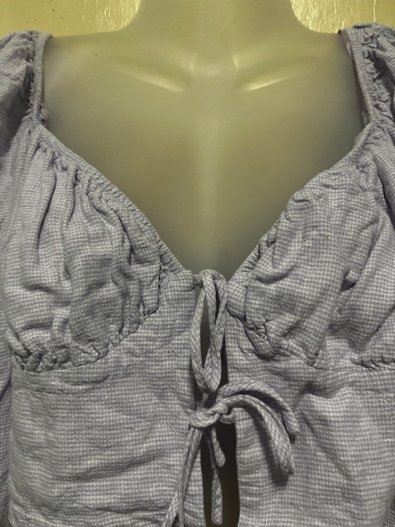 Light Purple Ruched Crop Top with Long Sleeves (Category: Longsleeves) located in Tabuk. Submitted by zenwolf-1867 (Listing ID 1470532172, Image 3). Description: - Color: Light purple with a subtle pattern - Neckline: Sweetheart neckline with chic bust ruching - Closure: Cute tie closure down the center front - Sleeves: Long sleeves with gathered shoulders and elastic cuffs - Fit: Cropped length that hits right at the waist - Feel: Made from a so