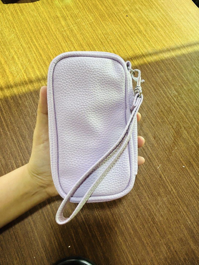 Light Purple Textured Pouch With Wrist Strap (Category: Purses & Pouches) located in Manila. Submitted by starbalesukandjapansurplus (Listing ID 1470555421, Image 1). Description: - Color: Light purple pebbled faux leather - Hardware: Silver-tone zipper closure - Strap: Removable wrist strap for versatile carrying - Interior: White lining with built-in mesh compartments for easy organization - Size: Compact and handy, perfect for daily essentials