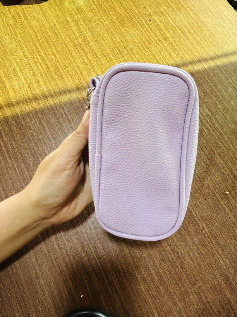 Light Purple Textured Pouch With Wrist Strap (Category: Purses & Pouches) located in Manila. Submitted by starbalesukandjapansurplus (Listing ID 1470555421, Image 3). Description: - Color: Light purple pebbled faux leather - Hardware: Silver-tone zipper closure - Strap: Removable wrist strap for versatile carrying - Interior: White lining with built-in mesh compartments for easy organization - Size: Compact and handy, perfect for daily essentials