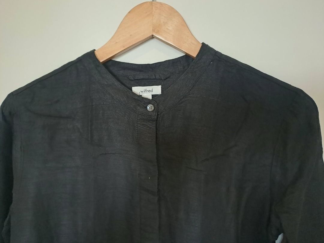 Linen tunic dress black (Category: Dresses) located in Mandaluyong City. Submitted by epicowl-c93c (Listing ID 1470385701, Image 2). Description: This garment is a black long-sleeve linen tunic dress featuring a classic band (or grandad) collar and a clean, button-down placket hidden down the front center line. Its minimalist aesthetic, relaxed silhouette, and lightweight, naturally textured linen weave make it an exceptionally versatile wardrobe