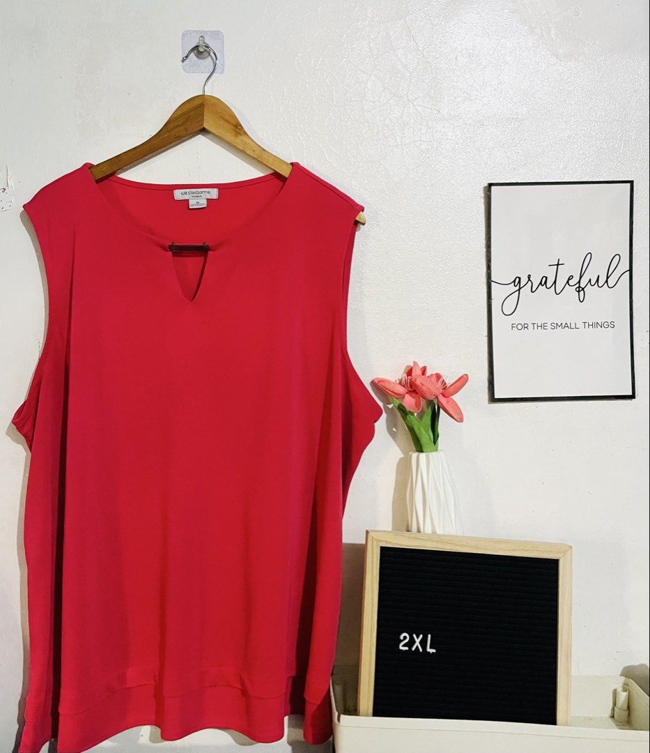Liz Claiborne Blouse (Category: Blouses) located in Caloocan City. Submitted by lovemyclothes21 (Listing ID 1470373409, Image 1). Description: - Brand: Liz Claiborne - Size: 2XL (indicated on tag and display board) - Color: Bold Red - Neckline: Round neck with trendy metal bar cutout detail - Hem: Layered hemline design - Fit: Relaxed and comfortable - Condition: Excellent, pre-loved/new - Perfect for: Warm days or easy layering.