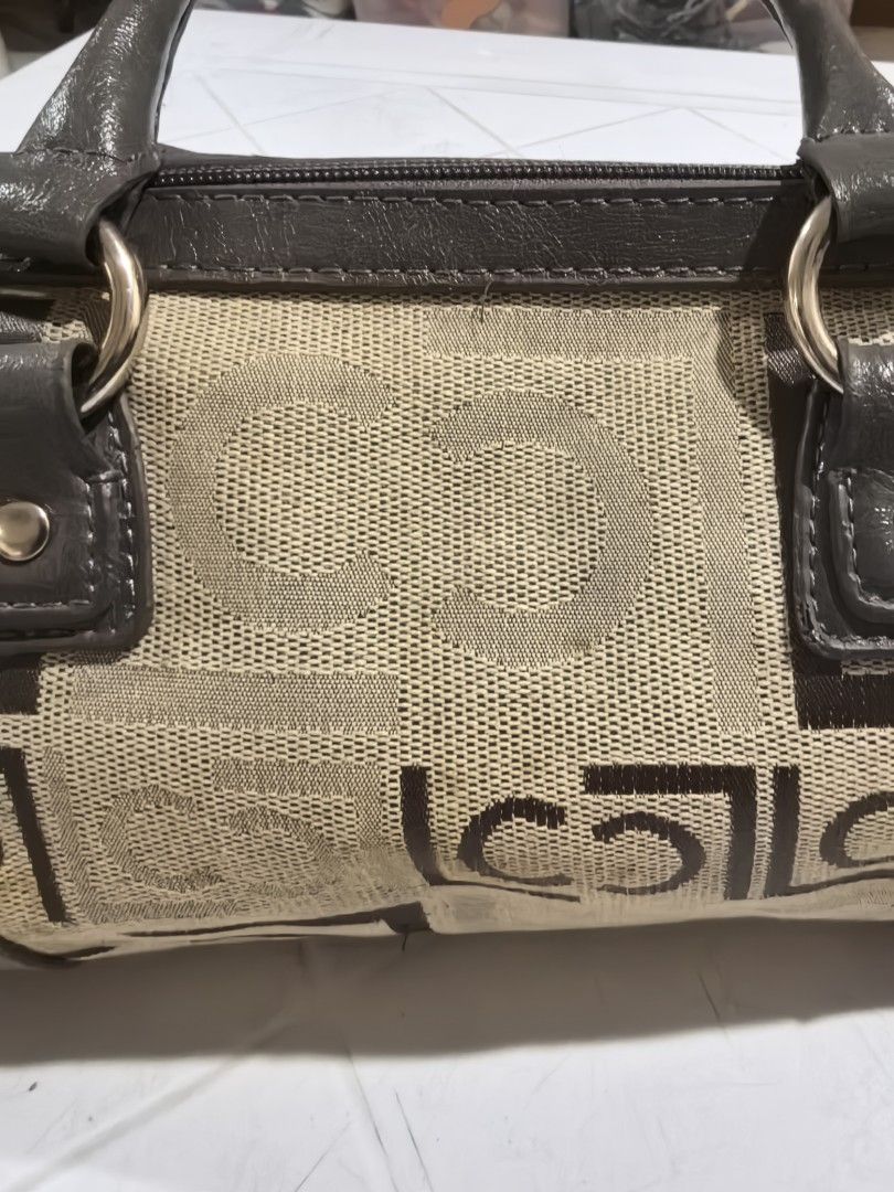 Liz Claiborne patterned barrel handbag (Category: Shoulder Bags) located in Manila. Submitted by jsu2026 (Listing ID 1470501079, Image 3). Description: - Brand: Liz Claiborne - Style: Barrel bag / Satchel - Color/Pattern: Beige and dark brown monogram canvas with grey faux leather trim and top handles - Closure: Zip-top closure - Interior: Plaid fabric lining with one zippered pocket and brand patch - Condition: Handles show regular handling wear
