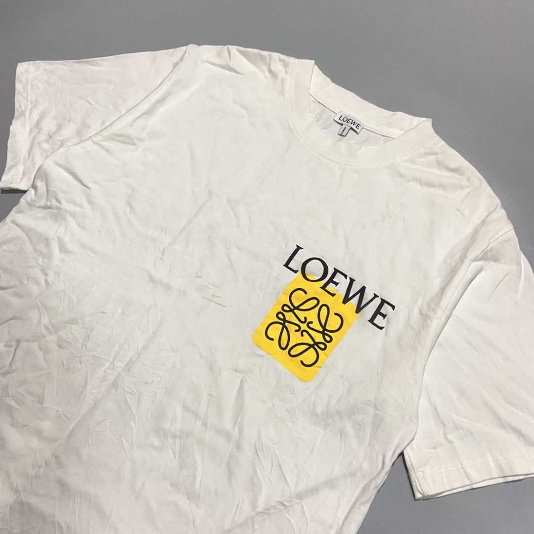 Loewe Anagram Tee (Category: Formal Shirts) located in Cebu City. Submitted by johngregmoldez03 (Listing ID 1470469411, Image 2). Description: Loewe Anagram Tee Size: Medium on tag Dimension: 22 Width / 27 Length Color Rate: 10/10 Excellent Condition - Need Wash / Slightly yellow stain Pm📩.