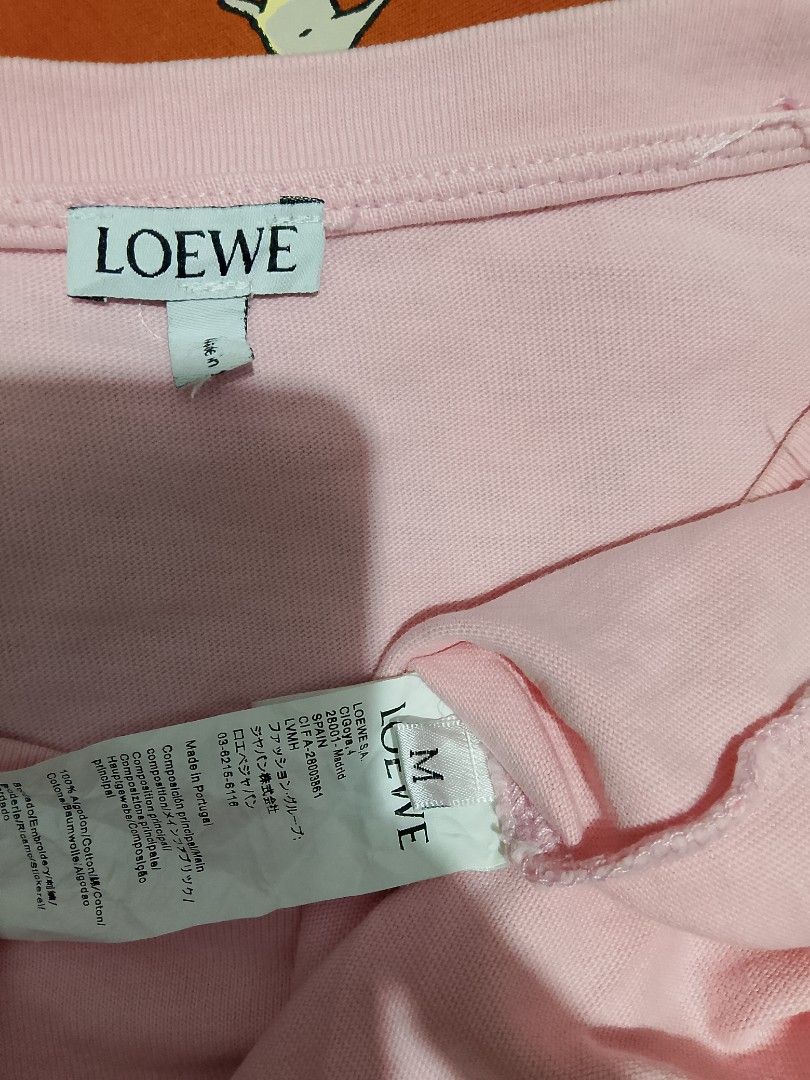 Loewe Pink T-shirt Size M (Category: Shirts) located in Caloocan City. Submitted by wirlynbina94604 (Listing ID 1470512008, Image 2). Description: - Brand: Loewe - Color: Pink - Size: Medium (tag attached) - Material: 100% Cotton - Design: Anagram graphic logo with embroidered accents on the front - Fit: Regular fit, round neckline - Origin: Made in Portugal - Style: Casual wear top.