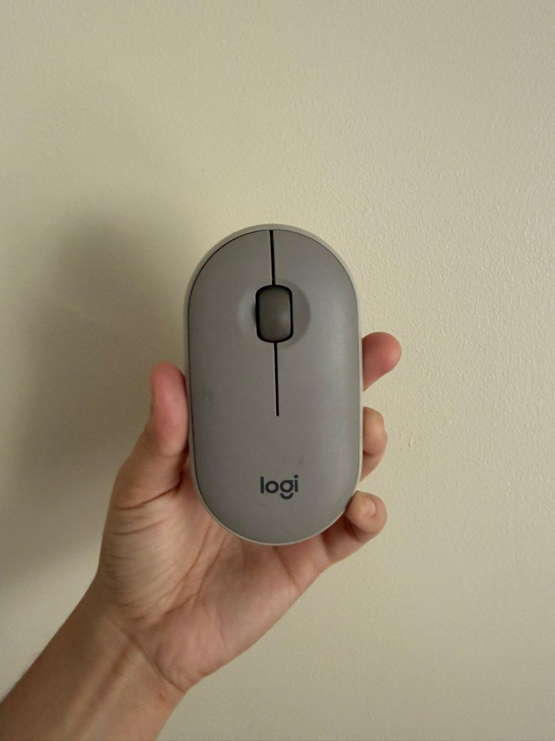 Logitech Pebble Wireless Mouse Grey (Category: Mouse & Mousepads) located in Taguig. Submitted by ashcoffee (Listing ID 1470370776, Image 1). Description: - Authentic Logitech Pebble wireless mouse in sleek grey - Slim and compact design, perfect for travel and on-the-go use - Dual connectivity: connects via Bluetooth or USB receiver - Smooth scrolling wheel and minimalist aesthetic - Battery-operated with easy-access power switch and pairing but