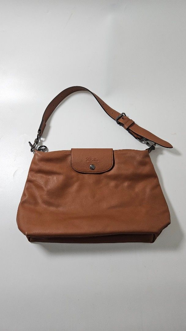 Longchamp Le Pliage Xtra Bag (Category: Luxury Bags & Wallets) located in Alfonso. Submitted by jbcamet (Listing ID 1470400615, Image 1). Description: - Brand: Longchamp - Material: Premium brown leather in rich tan with contrast stitching - Closure: Top zip closure with front flap pocket - Hardware: Silver-tone with iconic horse logo embossed on snap and zipper pulls - Strap: Adjustable strap with metal clips on both sides - Interior: Spacious m