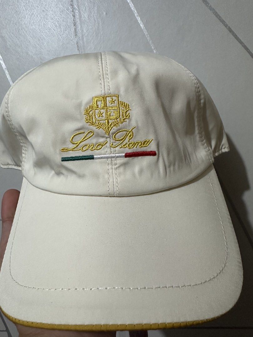 Loro Piana Bicolor Wind Baseball Cap (Category: Caps & Hats) located in Manila. Submitted by aoparaiso (Listing ID 1470503885, Image 1). Description: Loro Piana baseball cap in off-white with yellow accents and embroidered logo on the front. Features the Italian flag detail and Storm System lining with plaid pattern inside. Made in Italy Good condition with original red tag attached..