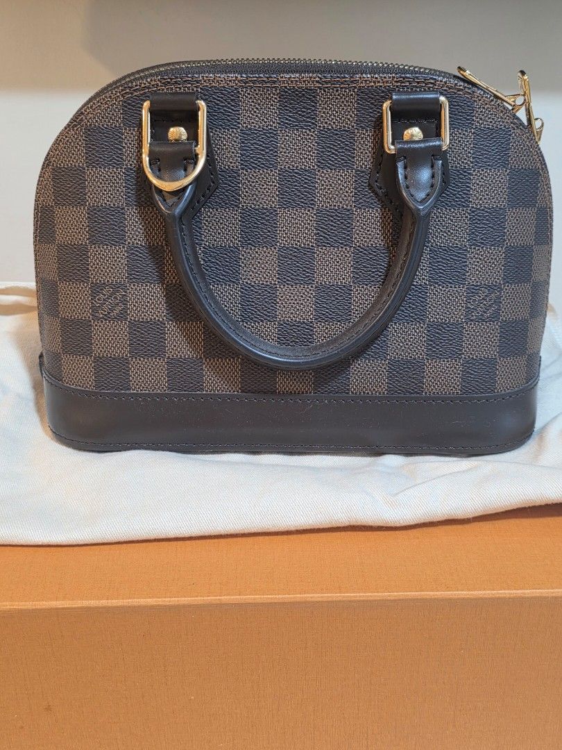 Louis Vuitton Alma BB Damier Ebene | Authentic | Lightly Used (Category: Luxury Bags & Wallets) located in Pasig City. Submitted by theprelovededitbyk (Listing ID 1470450033, Image 2). Description: Louis Vuitton Alma BB | Damier Ebene 🤎 Lightly used and well-maintained, with minimal signs of use. Personally purchased from a Louis Vuitton boutique. Comes with original accessories, dust bag, and inclusions as shown in photos. RFS: Closet declutter