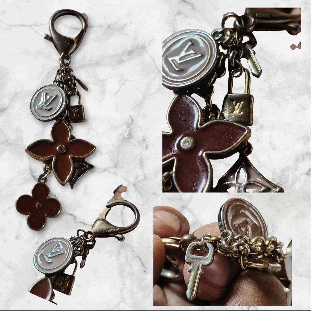 Louis Vuitton Bag Charm Keychain (Category: Charms) located in Baguio. Submitted by tabuzomaria1422 (Listing ID 1470463094, Image 1). Description: Louis Vuitton keyring and bag charm. Gold-tone hardware with engraved logo on the clasp. Includes dangling charms: a pink enamel LV circle medallion, brown enamel Monogram flower charms, a miniature padlock, and a key. Shows some tarnishing and wear on the metal parts..