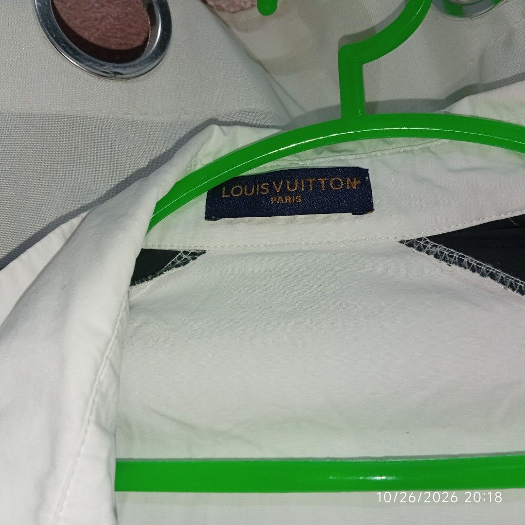 Louis Vuitton Contrast Sleeve Button Up Shirt (Category: Coats, Jackets and Outerwear) located in Taguig. Submitted by manilyn_lau (Listing ID 1470477367, Image 3). Description: - Color & Design: White button-up with contrasting black sleeves and LV sleeve lettering - Fit: Regular fit, size Medium - Features: Pointed collar, branded neck tag, and front button closure - Condition: Clean and ready to wear - Material: Comfortable fabric with interio