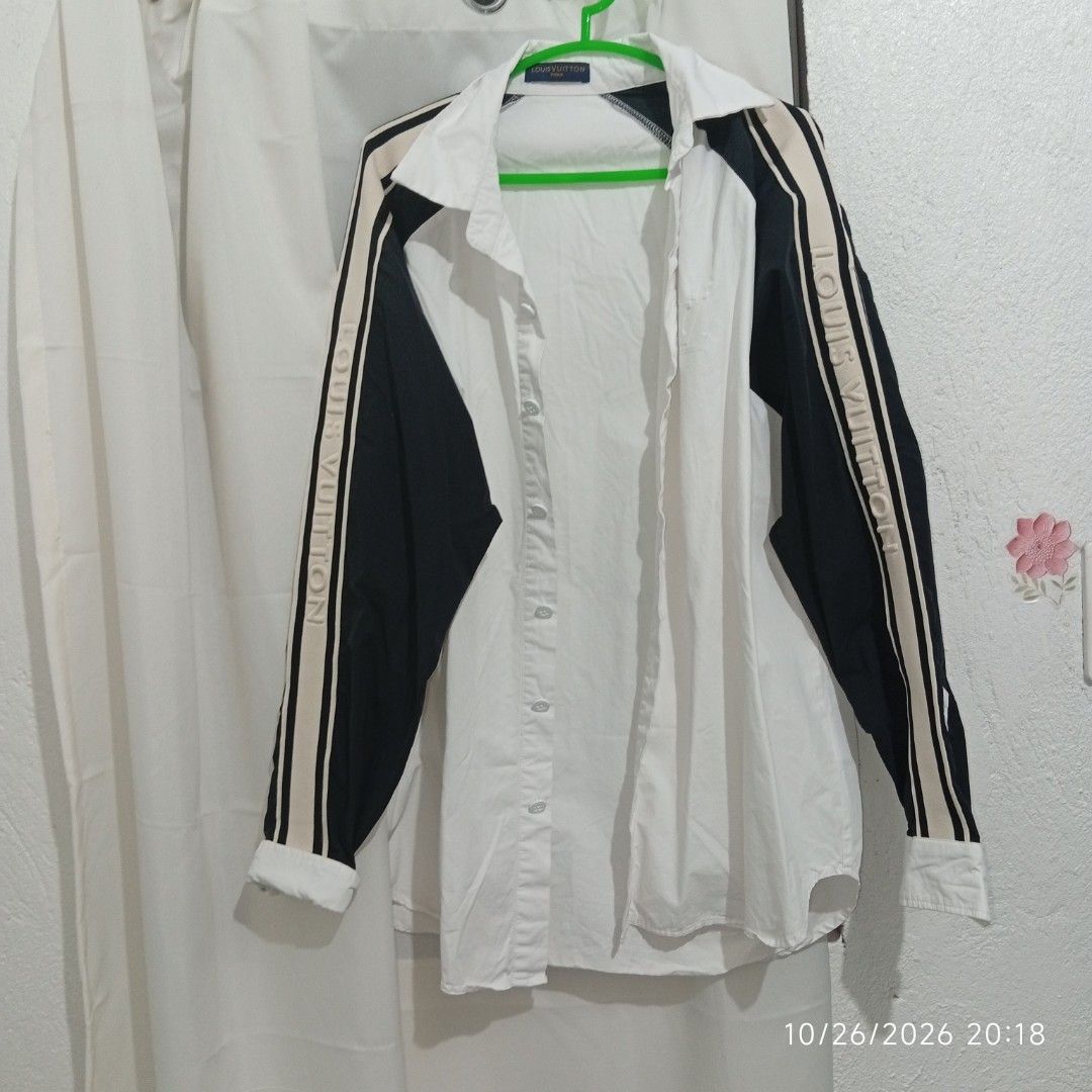 Louis Vuitton Contrast Sleeve Button Up Shirt (Category: Coats, Jackets and Outerwear) located in Taguig. Submitted by manilyn_lau (Listing ID 1470477367, Image 2). Description: - Color & Design: White button-up with contrasting black sleeves and LV sleeve lettering - Fit: Regular fit, size Medium - Features: Pointed collar, branded neck tag, and front button closure - Condition: Clean and ready to wear - Material: Comfortable fabric with interio