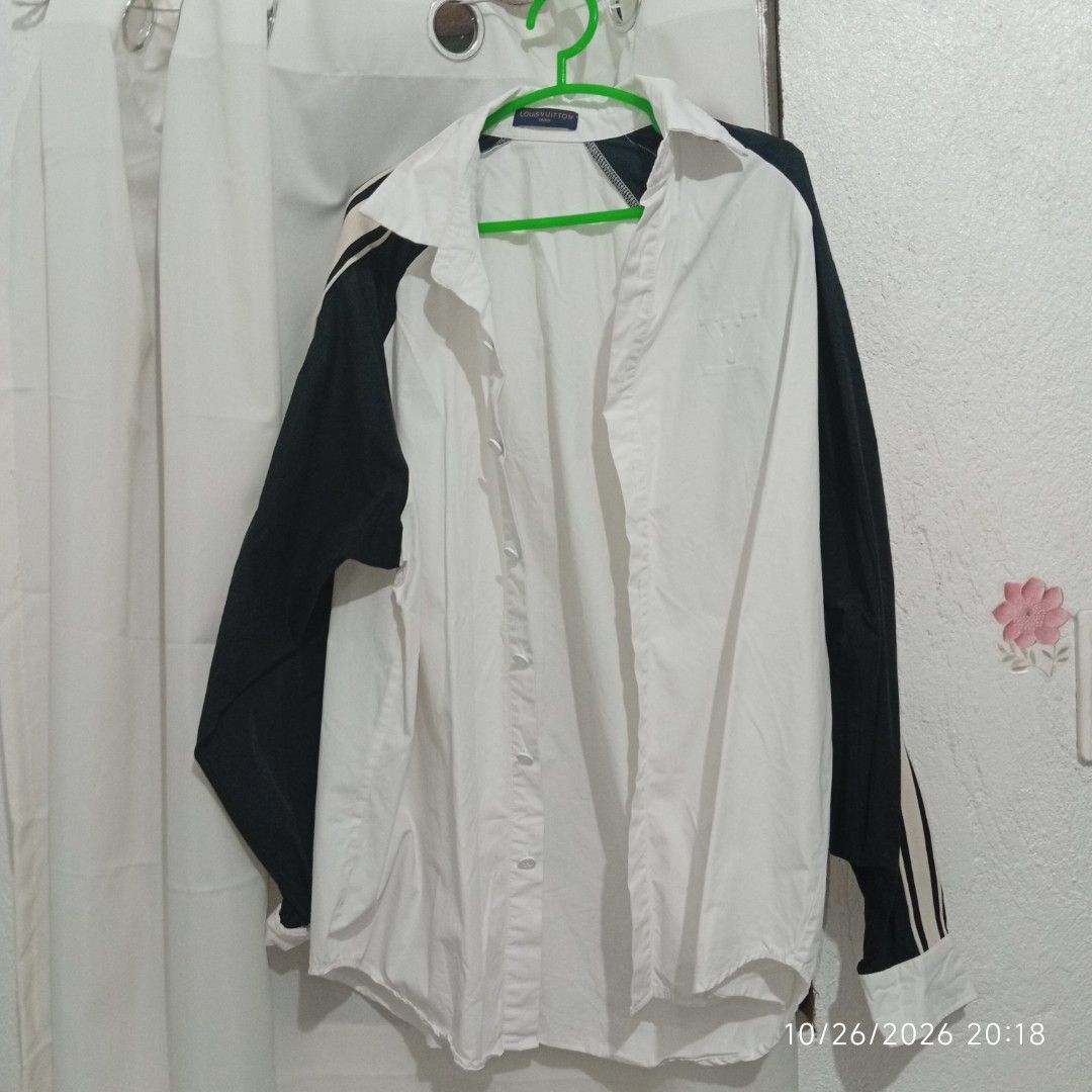 Louis Vuitton Contrast Sleeve Button Up Shirt (Category: Coats, Jackets and Outerwear) located in Taguig. Submitted by manilyn_lau (Listing ID 1470477367, Image 1). Description: - Color & Design: White button-up with contrasting black sleeves and LV sleeve lettering - Fit: Regular fit, size Medium - Features: Pointed collar, branded neck tag, and front button closure - Condition: Clean and ready to wear - Material: Comfortable fabric with interio