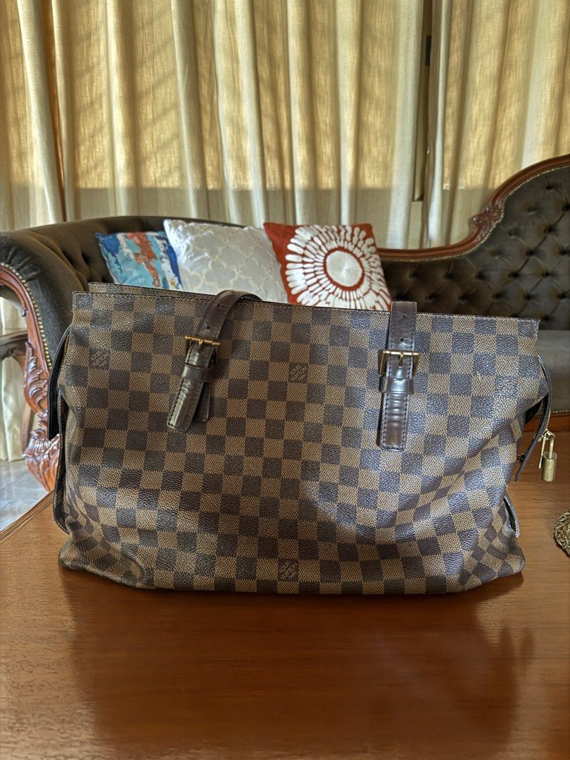 Louis Vuitton Damier Ebene Tote Bag (Category: Luxury Bags & Wallets) located in Lubao. Submitted by xpatriziam (Listing ID 1470413839, Image 3). Description: - Authentic Louis Vuitton tote in classic Damier Ebene canvas - Dark brown leather handles with adjustable buckle hardware - Secure top zip closure with gold-tone LV logo padlock - Structured shape featuring elegant dark brown leather side trim - Spacious everyday size, perfect for carrying