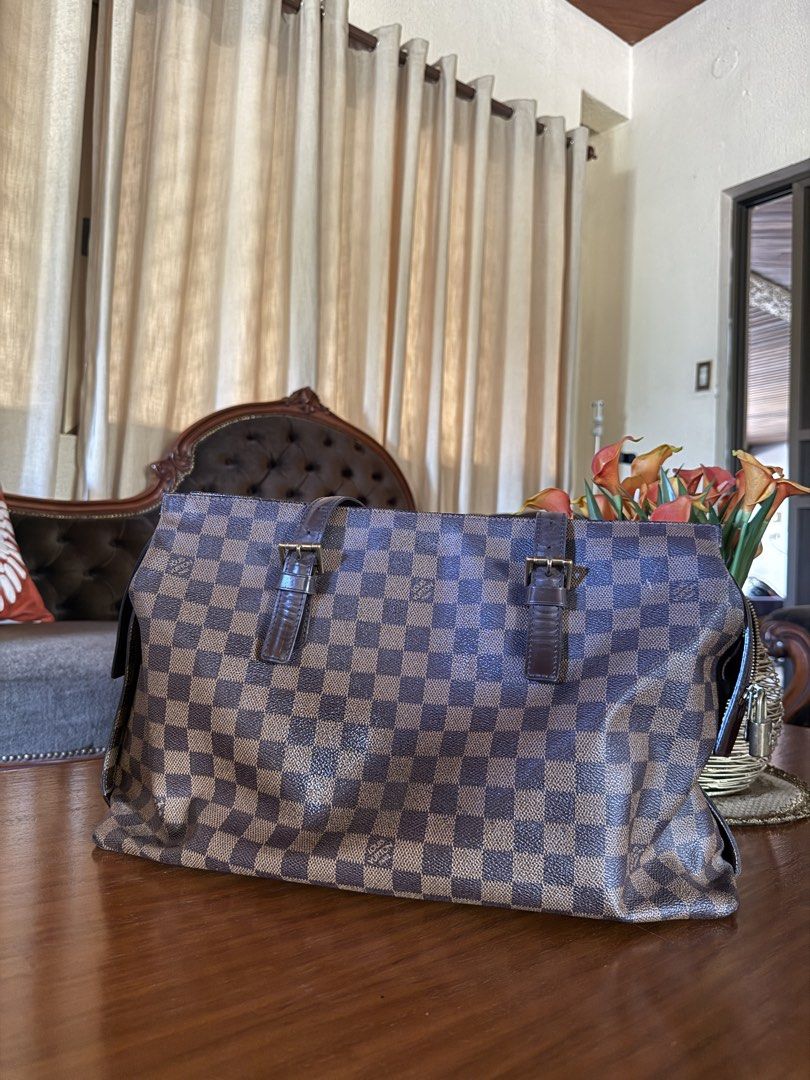 Louis Vuitton Damier Ebene Tote Bag (Category: Luxury Bags & Wallets) located in Lubao. Submitted by xpatriziam (Listing ID 1470413839, Image 2). Description: - Authentic Louis Vuitton tote in classic Damier Ebene canvas - Dark brown leather handles with adjustable buckle hardware - Secure top zip closure with gold-tone LV logo padlock - Structured shape featuring elegant dark brown leather side trim - Spacious everyday size, perfect for carrying