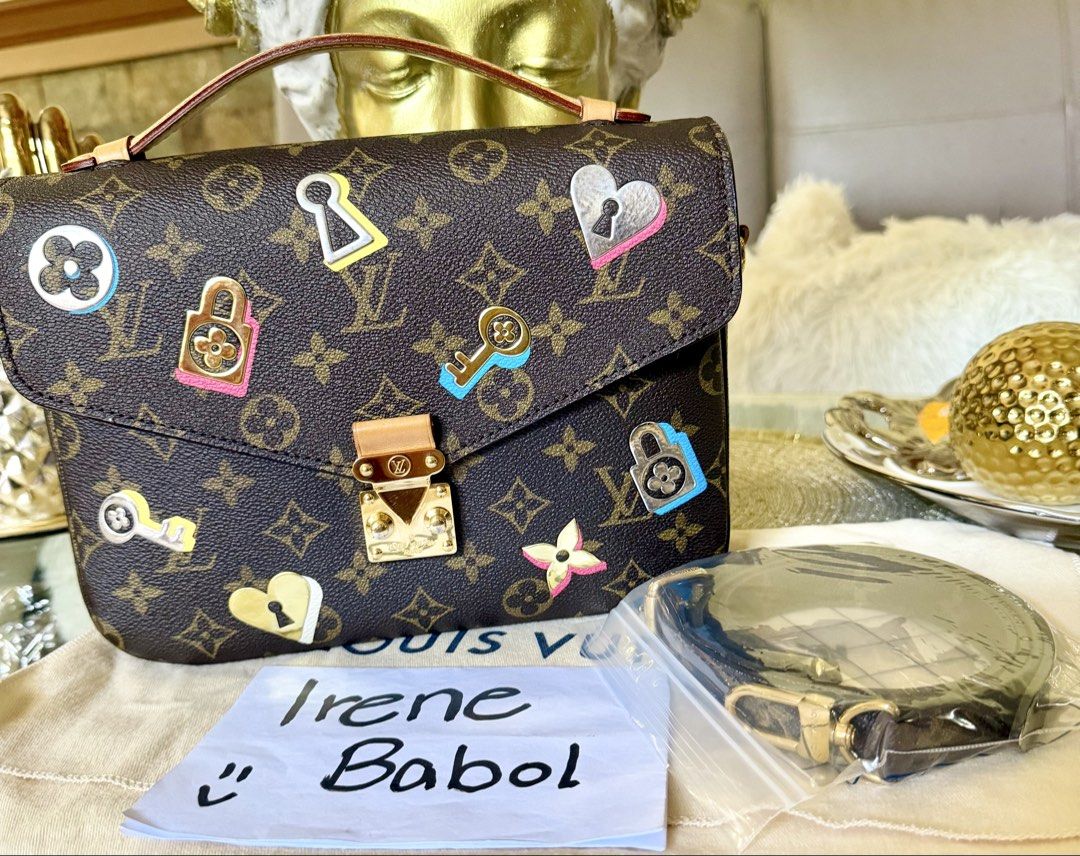 Louis Vuitton Monogram Canvas Sticker Pochette Metis Bag (Category: Luxury Bags & Wallets) located in Davao. Submitted by bribab (Listing ID 1470361247, Image 1). Description: - Brand: Louis Vuitton - Material: Classic brown monogram canvas with colorful lock and key patches - Interior: Bright pink lining with code tag DU4178 - Hardware: Gold-tone with front clasp closure - Inclusion: Top handle, adjustable shoulder strap (still in plastic wrap),