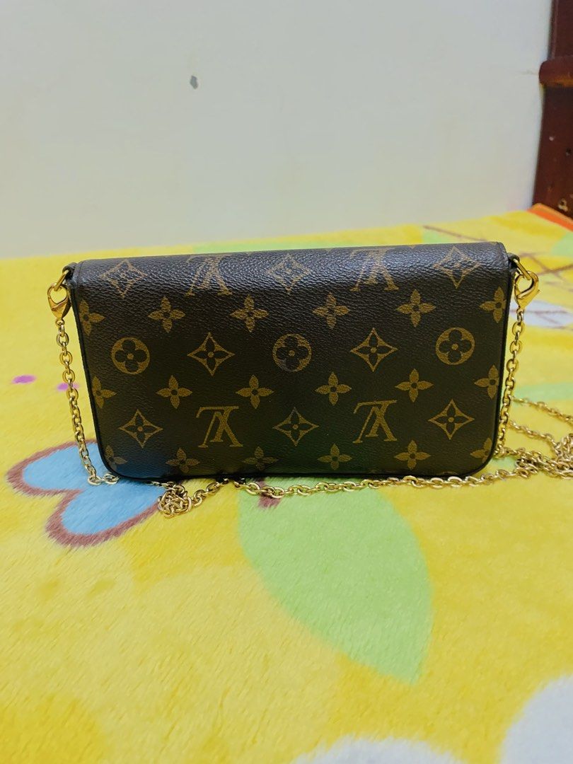 Louis Vuitton Monogram Canvas Envelope Chain Crossbody Bag (Category: Luxury Bags & Wallets) located in San Jose del Monte. Submitted by cityhanter007 (Listing ID 1470517405, Image 2). Description: - Louis Vuitton monogram coated canvas crossbody bag - Classic brown canvas with elegant gold-tone hardware - Secure envelope style flap closure with a snap button - Versatile removable chain strap with side dog clips - Clean dark brown interior lining