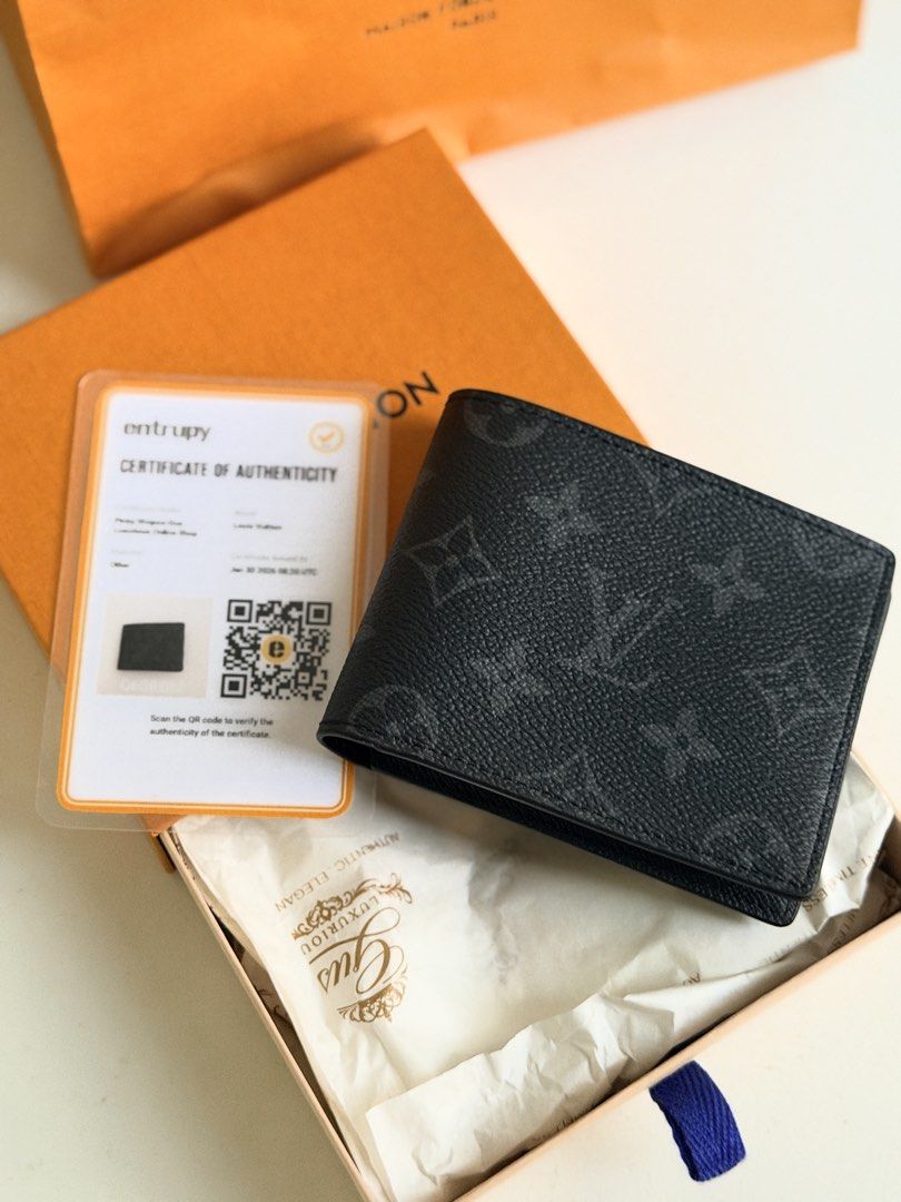 Louis Vuitton Monogram Eclipse Slender Wallet (Category: Luxury Bags & Wallets) located in Quezon City. Submitted by official_kiyowo.vintage (Listing ID 1470377287, Image 2). Description: - Authentic Louis Vuitton Monogram Eclipse bi-fold wallet - Sleek black and grey canvas design with compact layout - Features multiple card slots and a spacious bill compartment - Made in France stamp inside - Pristine condition, ideal for daily carry or gifting
