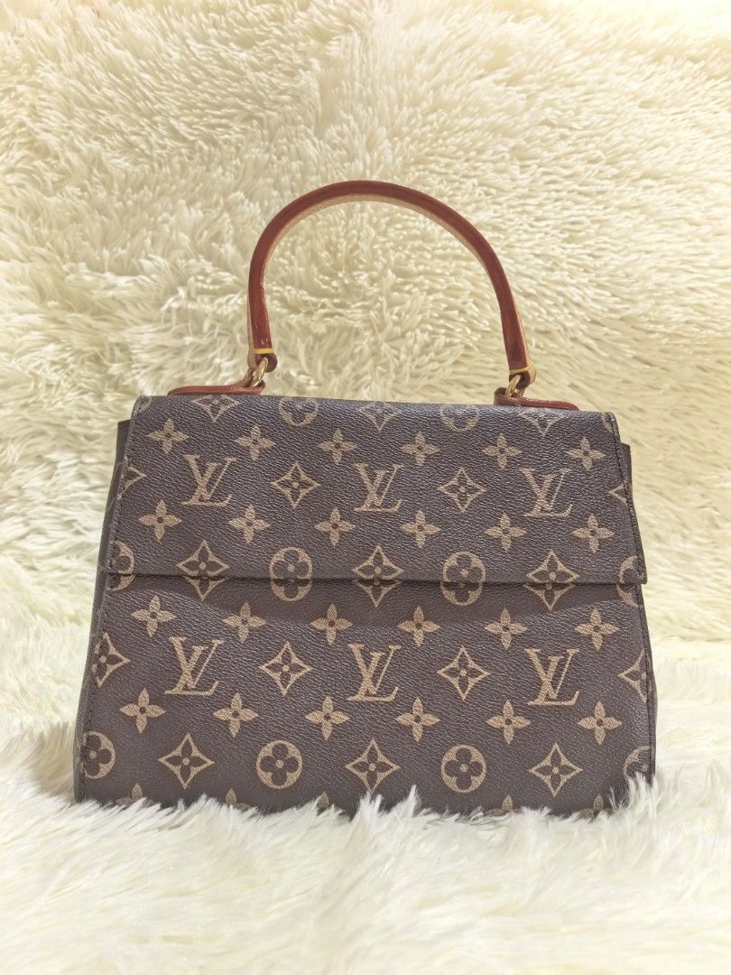 Louis Vuitton Monogram Handbag with Top Handle (Category: Luxury Bags & Wallets) located in Tacloban City. Submitted by thead.declutters (Listing ID 1470556485, Image 1). Description: - Authentic Louis Vuitton monogram canvas handbag - Classic brown and tan monogram pattern with structured shape - Elegant top handle and luxury gold-tone hardware - Secure front flap with snap closure - Vibrant pink fabric interior lining - Includes Louis Vuitton P