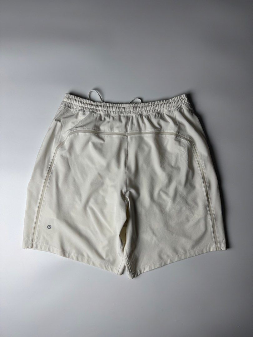 Lululemon ABC Shorts White Athletic Men (Category: Shorts) located in Cavite. Submitted by dracokidstuff (Listing ID 1470374739, Image 1). Description: - Brand: Lululemon - Color: Clean White - Size: 17" across waist (laid flat) - Features: Elastic waistband, adjustable drawstring with branded tips, side pockets, and back zip pocket - Details: Subtle Lululemon logo near the hem - Material: Lightweight performance fabric - Condition: Excellent - B