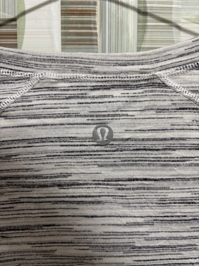 Lululemon Another Mile Short Sleeve (Category: Activewear) located in Caloocan City. Submitted by nlubon (Listing ID 1470458779, Image 3). Description: - Brand: Lululemon - Color/Pattern: Grey space dye - Features: Lightweight and breathable fabric with structured side panel seams - Details: Round neckline with signature reflective omega logo on upper back - Best for: Running, workouts, and casual gym wear.