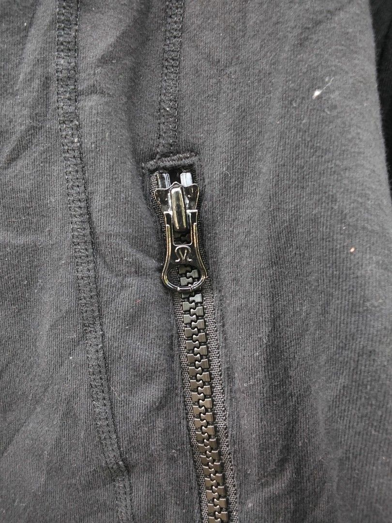Lululemon Black Full Zip Activewear Jacket (Category: Coats, Jackets and Outerwear) located in Quezon City. Submitted by quyss (Listing ID 1470447218, Image 3). Description: - Brand: Lululemon - Color: Classic Black - Design: Full front zip with a stylish high collar - Features: Two front zippered pockets, thumbholes on long sleeves, and signature omega logo on the back collar - Ventilation: Back vent cutout for extra breathability - Ideal for: G