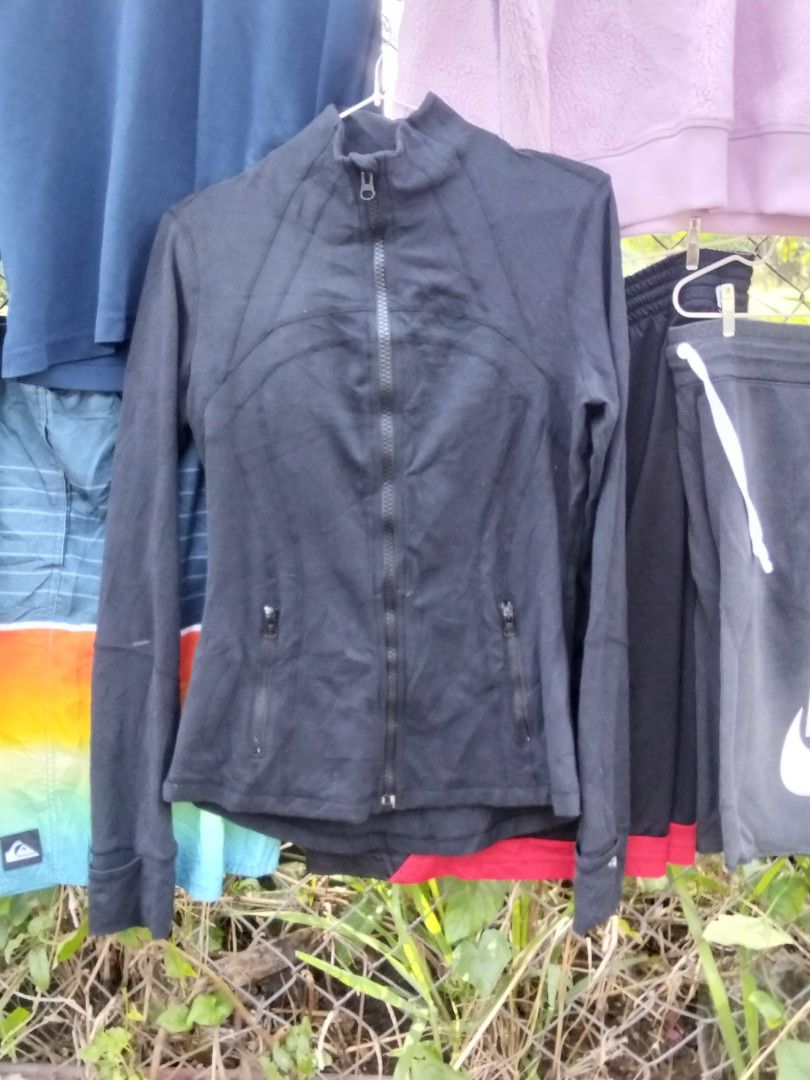 Lululemon Black Full Zip Activewear Jacket (Category: Coats, Jackets and Outerwear) located in Quezon City. Submitted by quyss (Listing ID 1470447218, Image 2). Description: - Brand: Lululemon - Color: Classic Black - Design: Full front zip with a stylish high collar - Features: Two front zippered pockets, thumbholes on long sleeves, and signature omega logo on the back collar - Ventilation: Back vent cutout for extra breathability - Ideal for: G