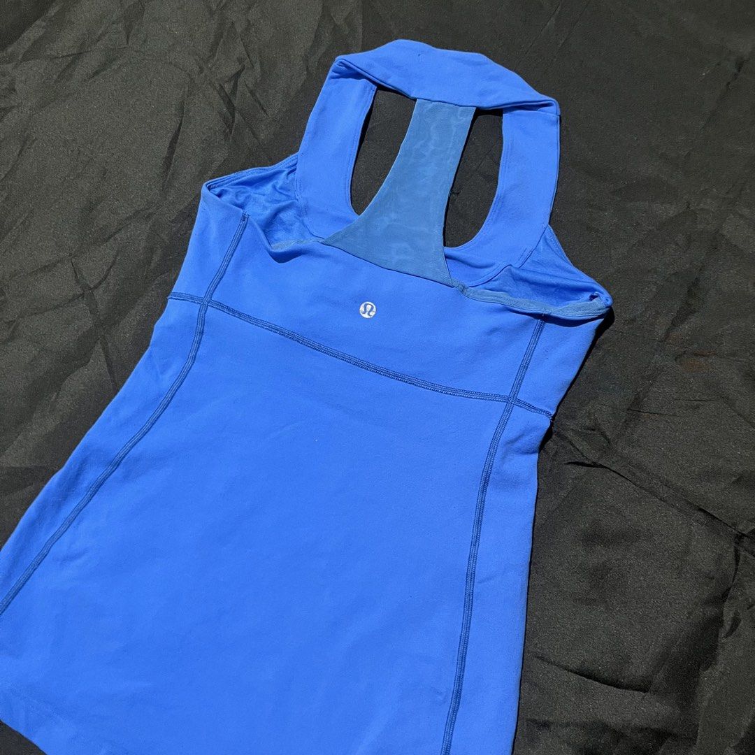 Lululemon Blue Athletic Tank Top with Racerback (Category: Activewear) located in Manila. Submitted by giormagne (Listing ID 1470446385, Image 1). Description: - Brand: Lululemon - Color: Bright blue - Design: Scoop neck front, racerback with a sheer blue back panel - Details: Classic silver omega logo on upper back, supportive ribbed seams along sides and waist - Versatility: Ideal for workouts, yoga, or everyday casual wear - Condition: Great p