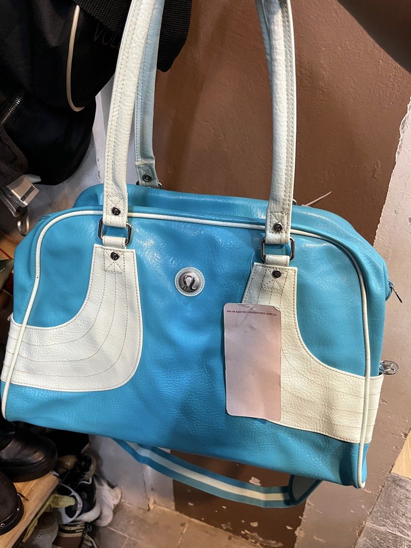 Lululemon Blue White Shoulder Bag Handbag (Category: Shoulder Bags) located in Tabuk. Submitted by collectors_thrift_shop (Listing ID 1470354043, Image 1). Description: - Authentic Lululemon shoulder bag in a vibrant blue and white colorway - Dual top handles plus a convenient, attached striped crossbody strap - Secure top-zip closure to keep your essentials safe - Stylish polka dot interior lining equipped with handy organizational pockets - Sig