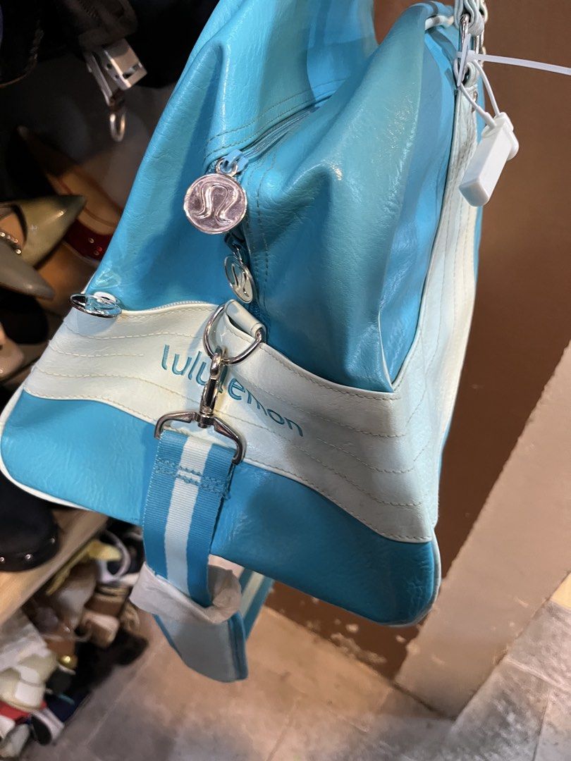 Lululemon Blue White Shoulder Bag Handbag (Category: Shoulder Bags) located in Tabuk. Submitted by collectors_thrift_shop (Listing ID 1470354043, Image 2). Description: - Authentic Lululemon shoulder bag in a vibrant blue and white colorway - Dual top handles plus a convenient, attached striped crossbody strap - Secure top-zip closure to keep your essentials safe - Stylish polka dot interior lining equipped with handy organizational pockets - Sig