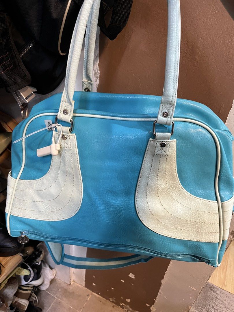 Lululemon Blue White Shoulder Bag Handbag (Category: Shoulder Bags) located in Tabuk. Submitted by collectors_thrift_shop (Listing ID 1470354043, Image 3). Description: - Authentic Lululemon shoulder bag in a vibrant blue and white colorway - Dual top handles plus a convenient, attached striped crossbody strap - Secure top-zip closure to keep your essentials safe - Stylish polka dot interior lining equipped with handy organizational pockets - Sig