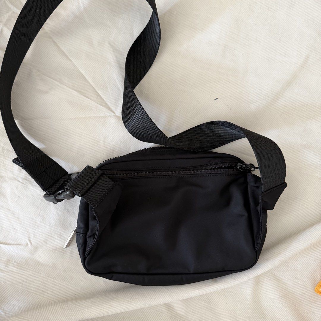 Lululemon Everywhere Belt Bag Black (Category: Cross-body Bags) located in Manila. Submitted by jlssntg (Listing ID 1470429339, Image 2). Description: - Authentic Lululemon Everywhere Belt Bag in versatile solid black - Made from durable, water-repellent nylon fabric - Adjustable strap with a secure buckle closure - Main zippered compartment with organized internal mesh pockets - Exterior back zipper pocket for quick-access items like cards and k