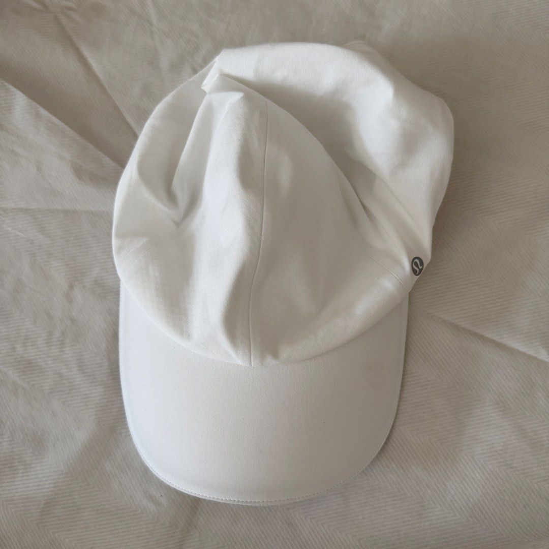 lululemon White Running Cap Hat (Category: Hats & Beanies) located in Manila. Submitted by jlssntg (Listing ID 1470429566, Image 2). Description: - Brand: Lululemon - Color: Clean white - Style: Classic curved brim with subtle reflective logo - Material: Breathable, easy to wash, and quick-drying fabric - Fit: Adjustable strap at the back for a custom fit - Ideal for: Workouts, runs, or everyday outdoor use.