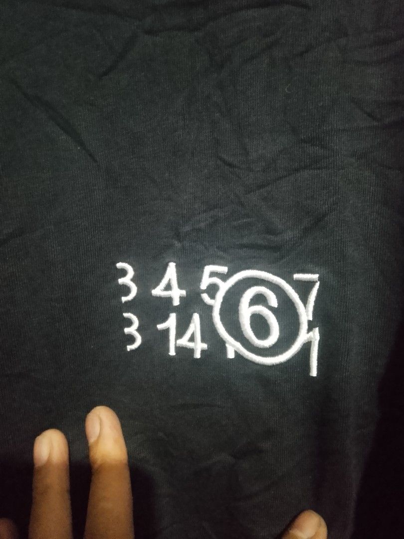 Maison Margiela MM6 Black Number Tee (Category: Shirts) located in Quezon City. Submitted by theoneshop1 (Listing ID 1470463062, Image 2). Description: - Brand: MM6 Maison Margiela - Color: Black with white number print on chest - Fit: Relaxed fit with classic crewneck - Details: Iconic four white stitches on the back neck - Material: Soft, premium cotton - Origin: Made in Italy.