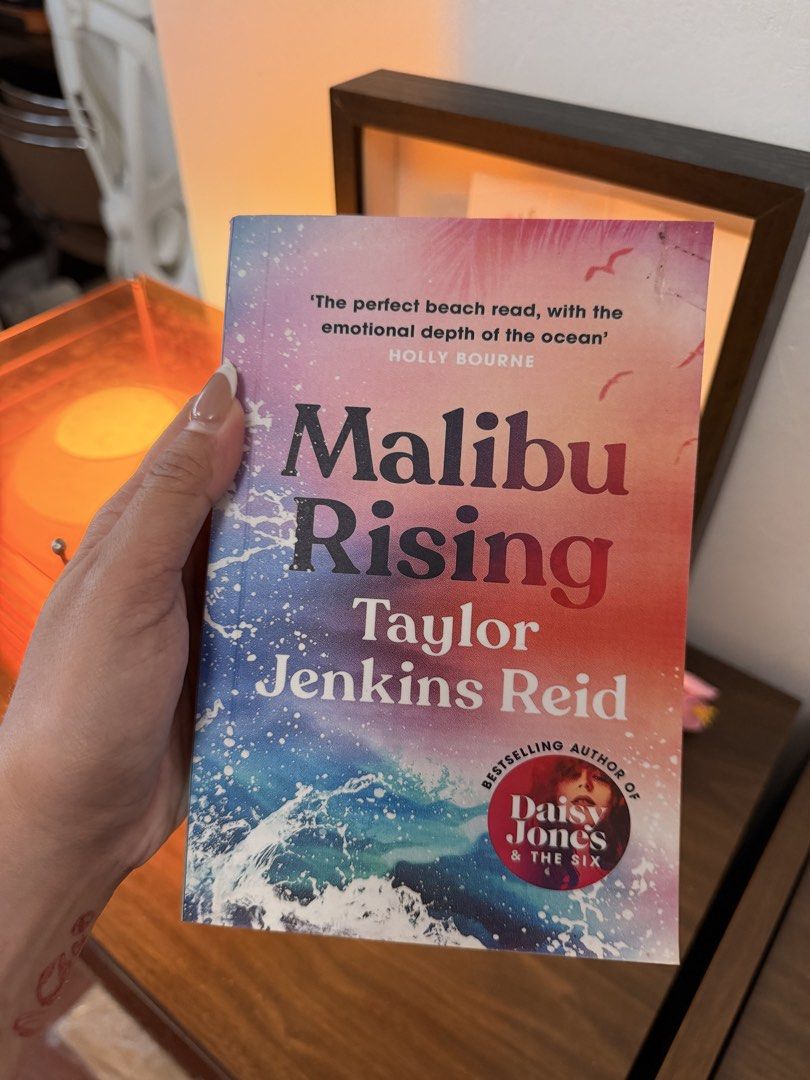 Malibu Rising (unofficial reprint? (Category: Storybooks) located in Santa Cruz. Submitted by izaaaaaaaaaaa1216 (Listing ID 1470401665, Image 1). Description: - Title: Popular fiction novel by Taylor Jenkins Reid (Author of Daisy Jones & The Six) - Edition: Paperback with colorful ocean cover - Condition: Read once, clean pages, intact spine - Availability: Ready for the next reader - Shipping/Meet-up: Ships from the Philippines / PM to order.