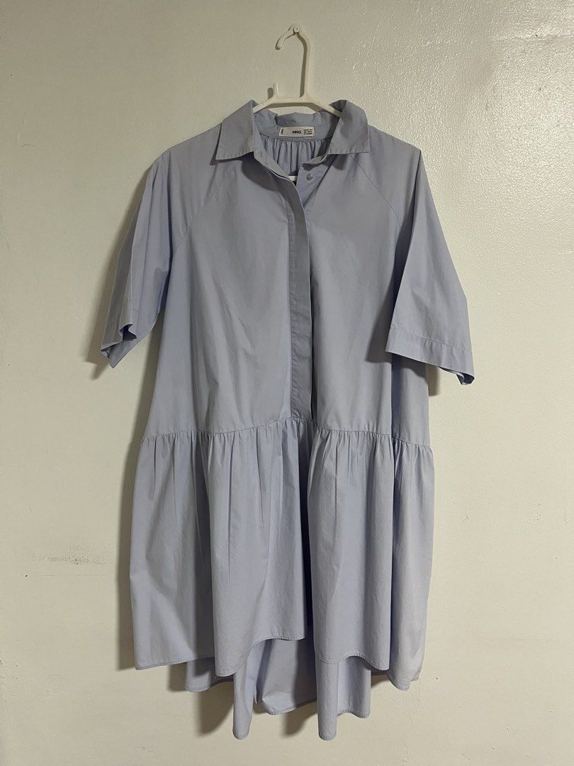 Mango Light Blue Shirt Dress (Category: Dresses) located in Cabuyao City. Submitted by rdtrmt (Listing ID 1470409262, Image 1). Description: - Brand: Mango - Color: Light blue - Size: EUR/USA XS/S (MEX ECH/CH, CN M-160/84A) - Design: Collared neckline, front button placket, short sleeves, and a gathered dropped waist with a tiered, flared silhouette - Fit: Relaxed and breezy - Condition: Clean and well-kept, perfect for warm casual days. Still in