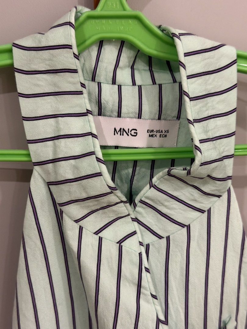 MANGO (MNG) Striped Halter Wrap Top (Category: Sleeveless) located in Muntinlupa City. Submitted by closet.natalia (Listing ID 1470478365, Image 3). Description: MANGO (MNG) Striped Halter Wrap Top ● Brand: MANGO (MNG) ● Color: Light mint green with dark stripes ● Vertical pinstripe pattern ● Halter neckline with collar detail ● Wrap-style front with adjustable side ties ● Asymmetrical pointed hem 📌 Payment: GCash, BPI bank transfer, or PayPal O