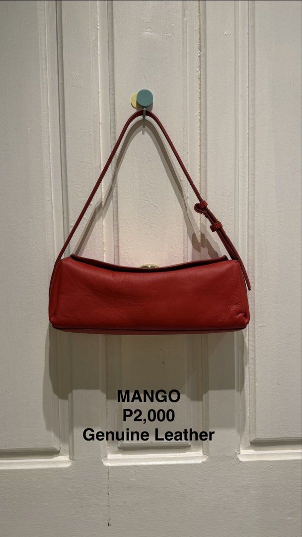 Mango Red Genuine Leather Shoulder Bag (Category: Shoulder Bags) located in Manila. Submitted by annamacuto (Listing ID 1470466259, Image 1). Description: - Brand: Mango - Material: Genuine leather in a rich red finish - Design: Structured rectangular shape with a minimalist style - Closure & Hardware: Top flap closure with elegant gold-tone hardware - Strap: Adjustable strap with metal buckles and standard shoulder drop length - Condition: Clean